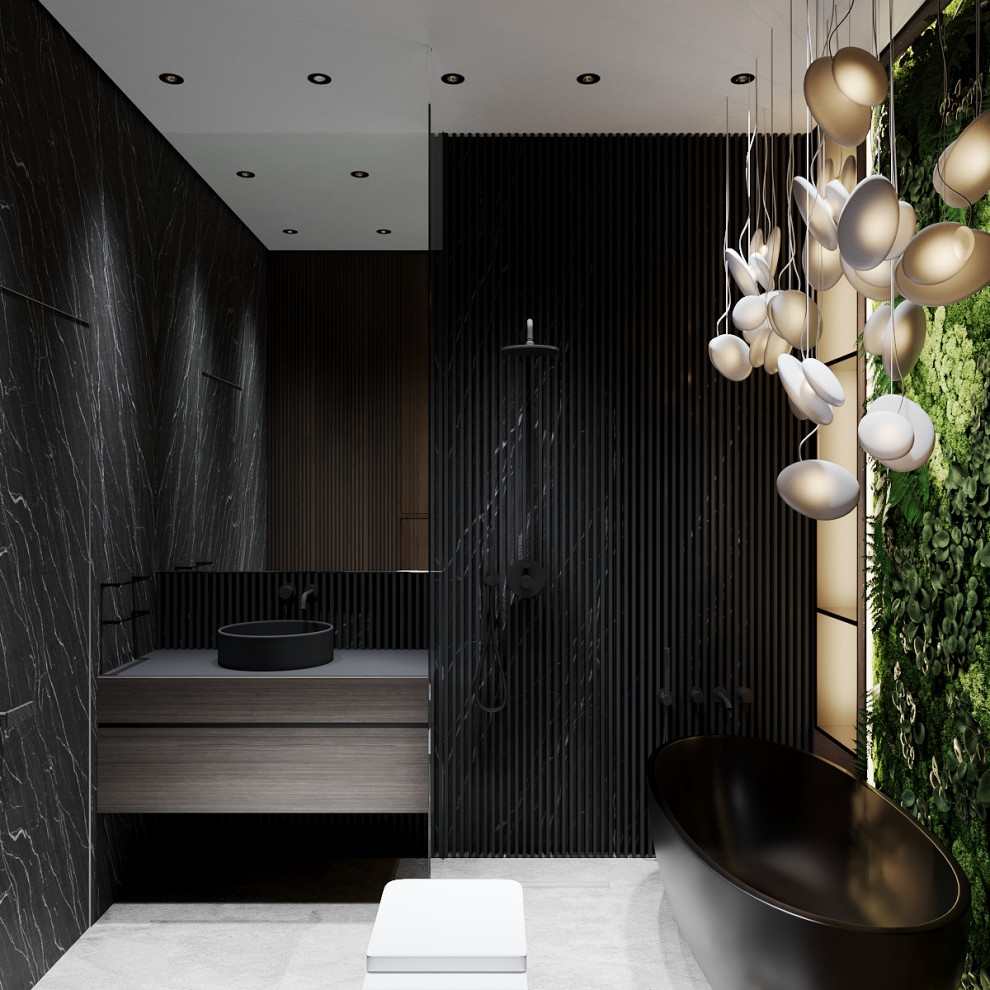 Modern inredning av ett mellanstort svart svart en-suite badrum, med öppna hyllor, svarta skåp, ett fristående badkar, en kantlös dusch, en vägghängd toalettstol, svart kakel, svarta väggar, klinkergolv i porslin, ett nedsänkt handfat, vitt golv och med dusch som är öppen