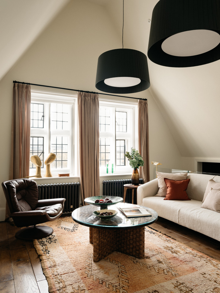 Inspiration for a traditional living room in London with beige walls, dark hardwood flooring, brown floors and a vaulted ceiling.