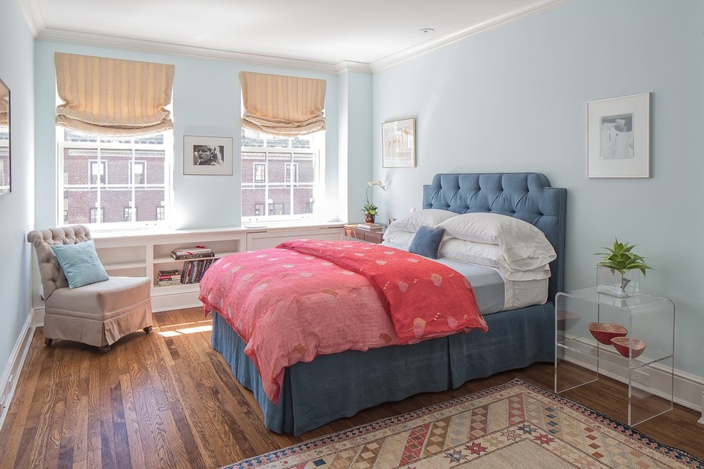 Inspiration for a transitional bedroom in New York with blue walls, medium hardwood floors and no fireplace.