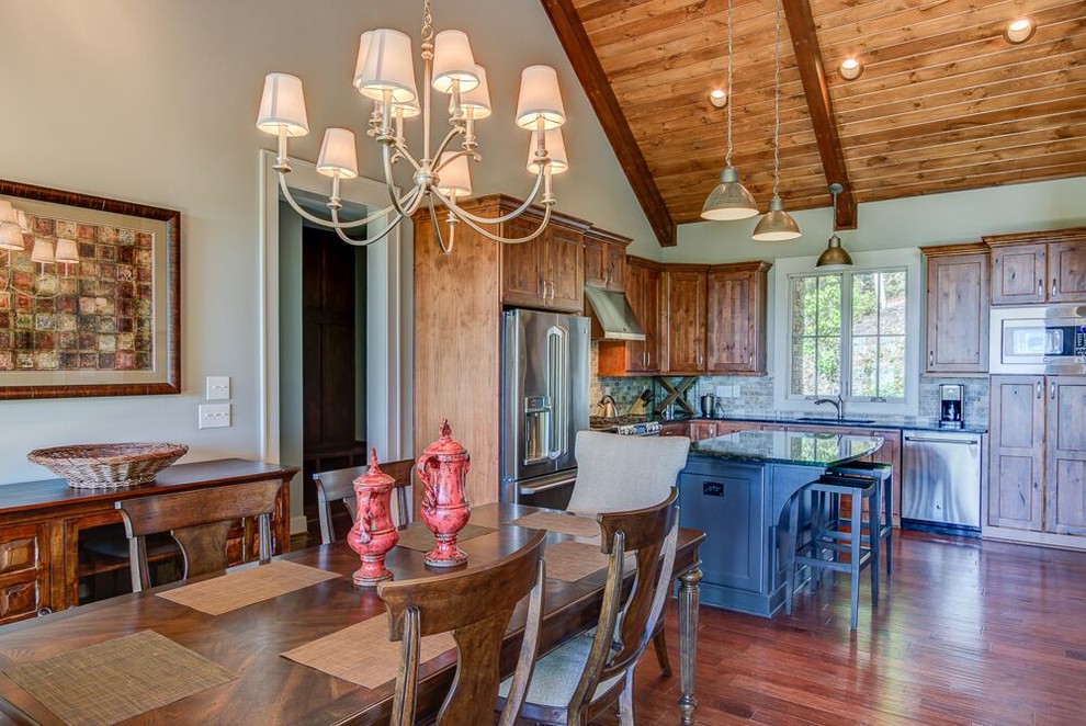 Inspiration for an arts and crafts l-shaped eat-in kitchen in Charlotte with shaker cabinets, distressed cabinets, granite benchtops, porcelain splashback, stainless steel appliances, medium hardwood floors and with island.
