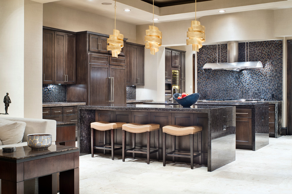 Inspiration for a large transitional galley enclosed kitchen remodel in Houston with dark wood cabinets, multicolored backsplash and two islands