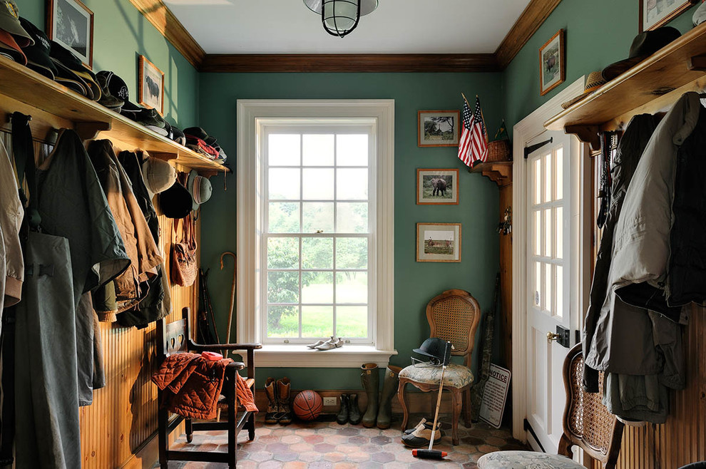 Design ideas for a traditional mudroom in New York with green walls.