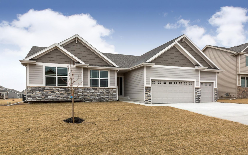 Inspiration for a large transitional gray one-story vinyl gable roof remodel with a shingle roof