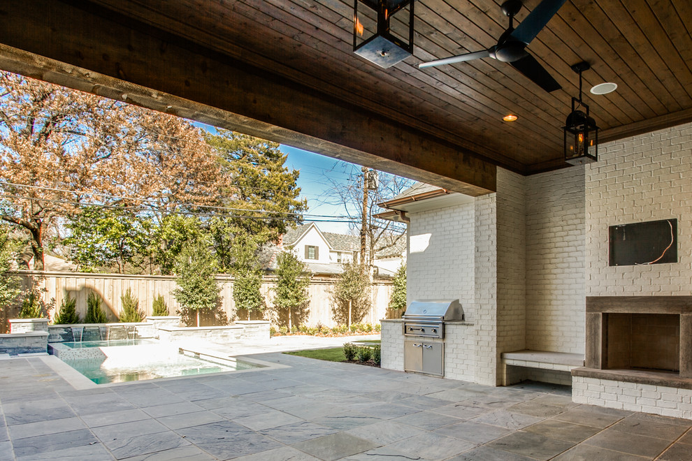 Large transitional backyard verandah in Dallas with a fire feature, a roof extension and natural stone pavers.