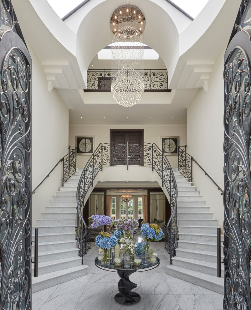 Inspiration for an expansive traditional curved staircase in London.
