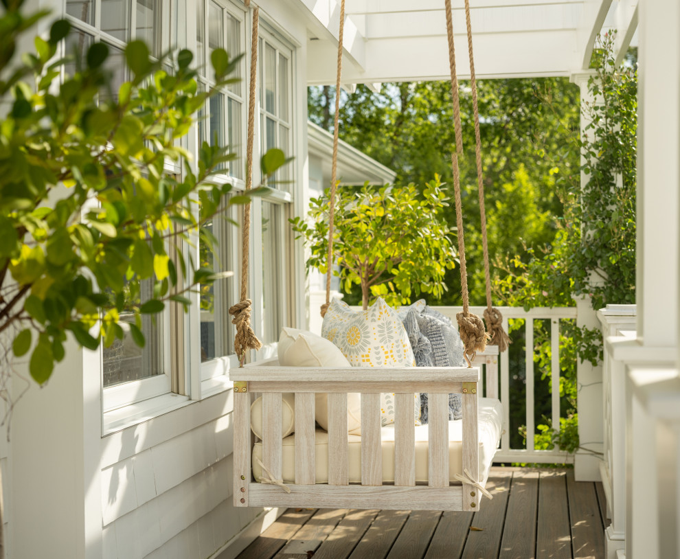 Inspiration for a large beach style front yard verandah in Other with with columns, a pergola and mixed railing.