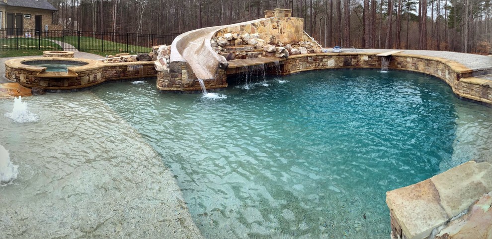 Large mountain style backyard stone and custom-shaped natural pool fountain photo in Atlanta