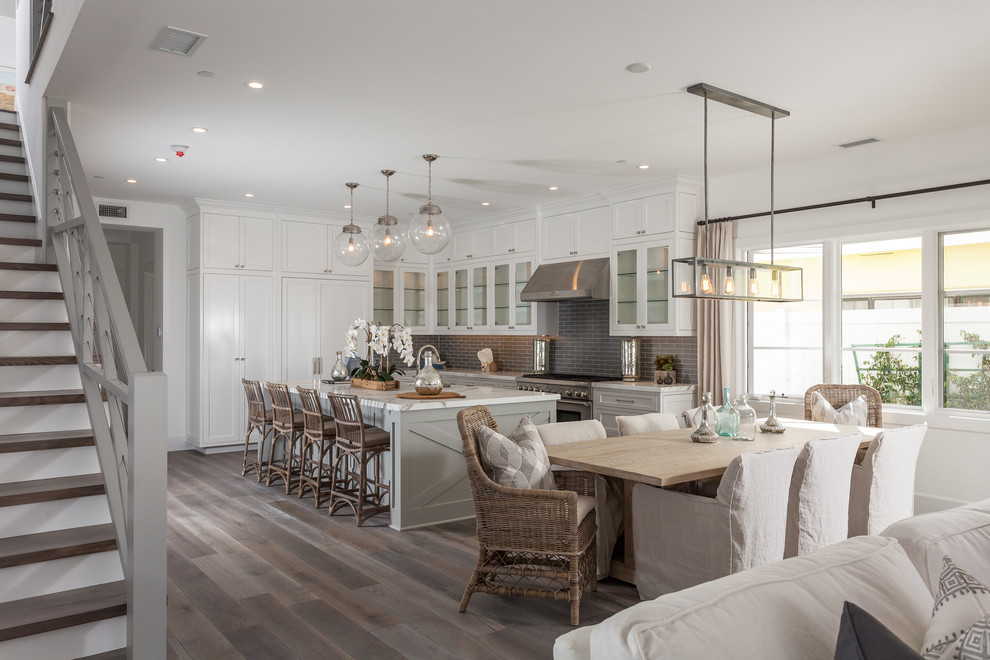 Design ideas for a mid-sized beach style kitchen/dining combo in Orange County with white walls and dark hardwood floors.