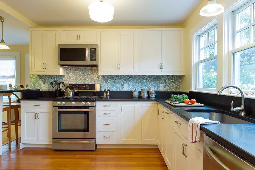 This is an example of a beach style kitchen in Boston with stainless steel appliances.