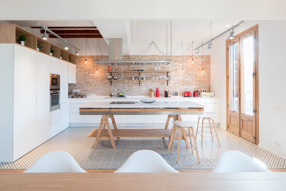 Large contemporary eat-in kitchen in Barcelona with flat-panel cabinets, white cabinets, marble benchtops, porcelain floors, with island, an undermount sink, brick splashback, stainless steel appliances and multi-coloured floor.