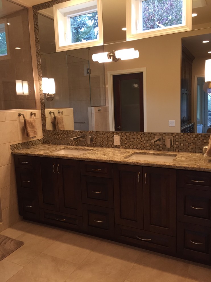 Design ideas for a large traditional master bathroom in Seattle with raised-panel cabinets, medium wood cabinets, a two-piece toilet, beige tile, porcelain tile, porcelain floors, an undermount sink and engineered quartz benchtops.