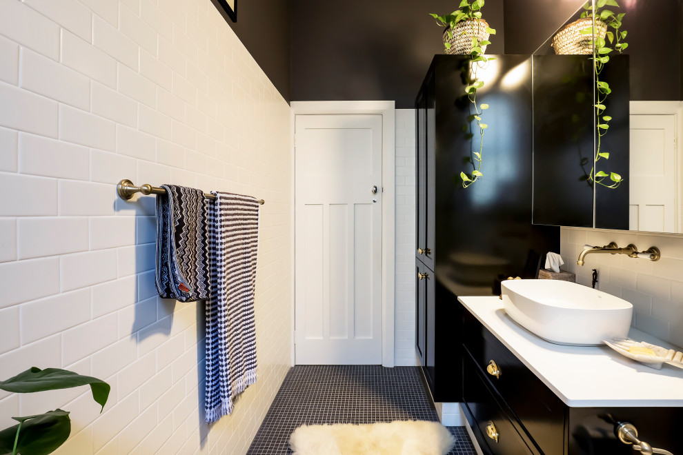 Пример оригинального дизайна: маленькая ванная комната со стиральной машиной в классическом стиле с фасадами в стиле шейкер, черными фасадами, открытым душем, унитазом-моноблоком, белой плиткой, керамической плиткой, черными стенами, полом из мозаичной плитки, душевой кабиной, настольной раковиной, столешницей из искусственного кварца, черным полом, открытым душем, белой столешницей, тумбой под одну раковину и встроенной тумбой для на участке и в саду