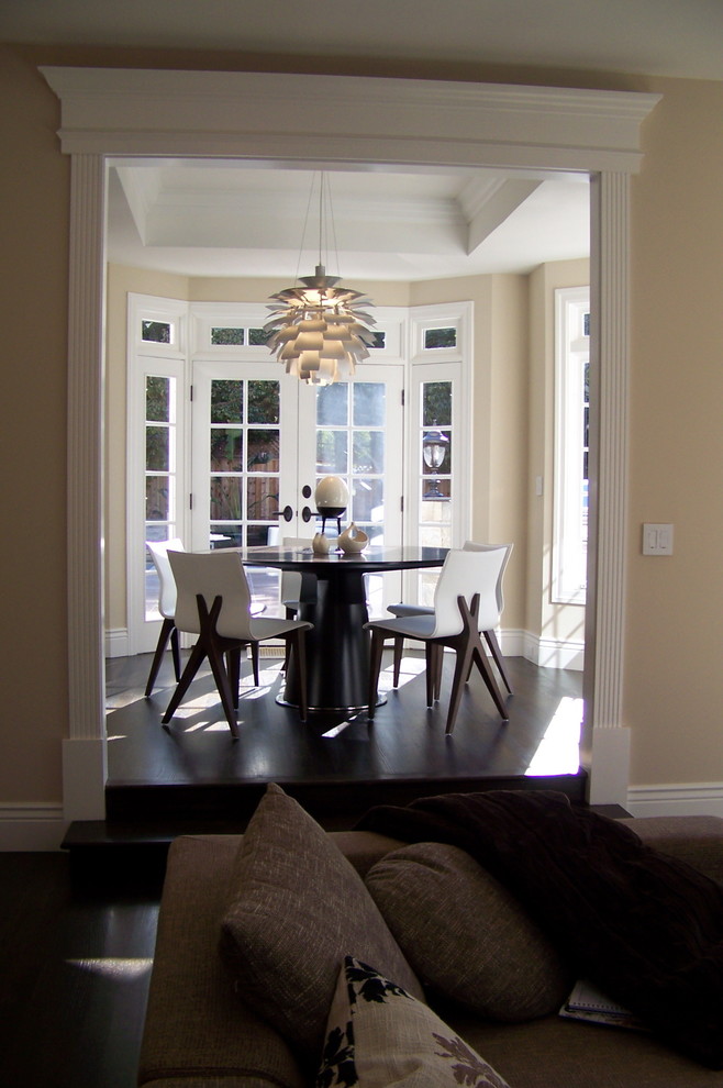 Contemporary dining room in San Francisco with beige walls and dark hardwood floors.