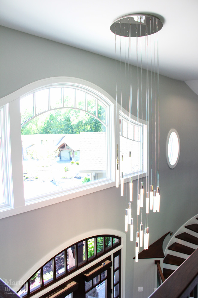 Foyer - large transitional dark wood floor and vaulted ceiling foyer idea with gray walls and a dark wood front door