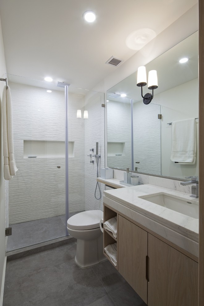 This is an example of a small modern bathroom in Other with light wood cabinets, an open shower, a one-piece toilet, white tile, porcelain tile, white walls, porcelain floors, a drop-in sink, marble benchtops and flat-panel cabinets.