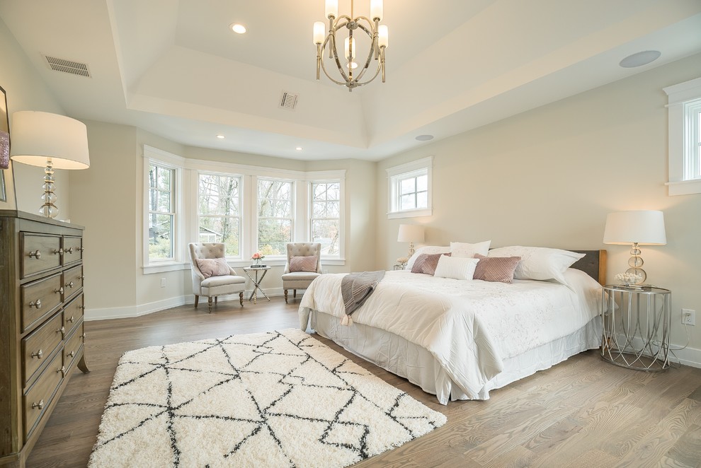 Design ideas for a transitional bedroom in New York with beige walls, medium hardwood floors and brown floor.