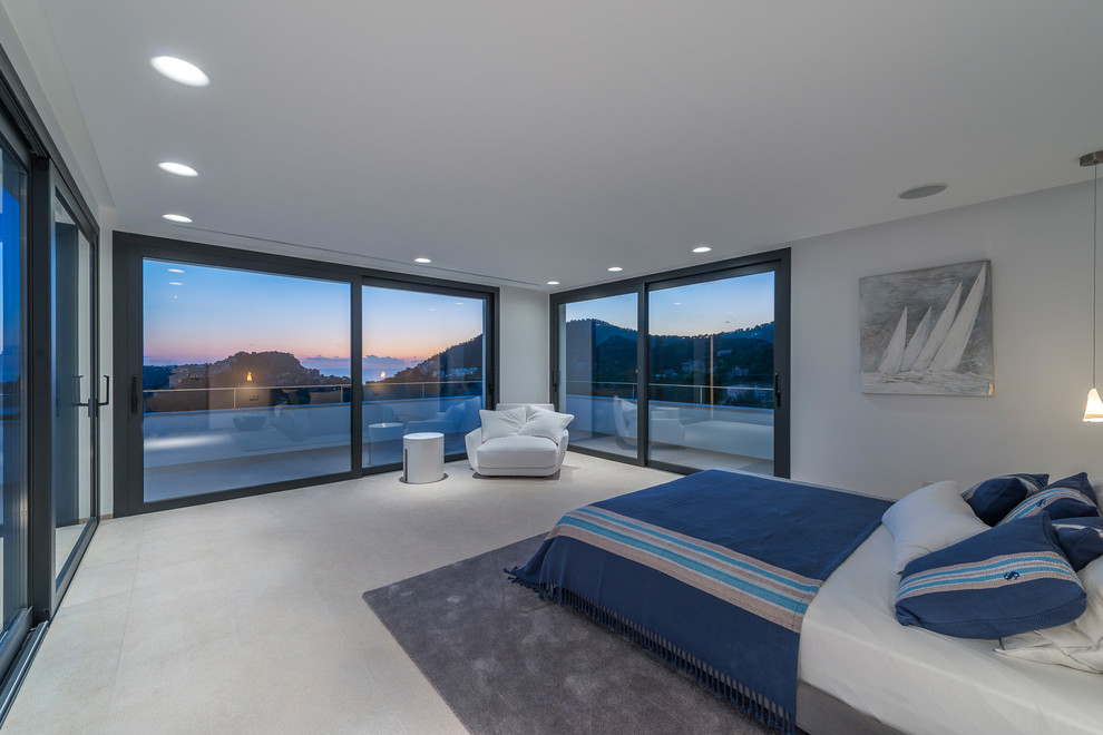 Photo of a large beach style master bedroom in Palma de Mallorca with white walls and no fireplace.