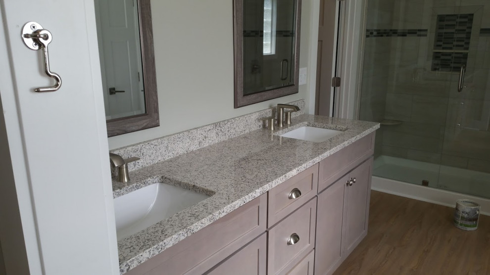 Design ideas for a large arts and crafts master bathroom in Wilmington with shaker cabinets, grey cabinets, beige tile, green walls, laminate floors, granite benchtops, brown floor and beige benchtops.