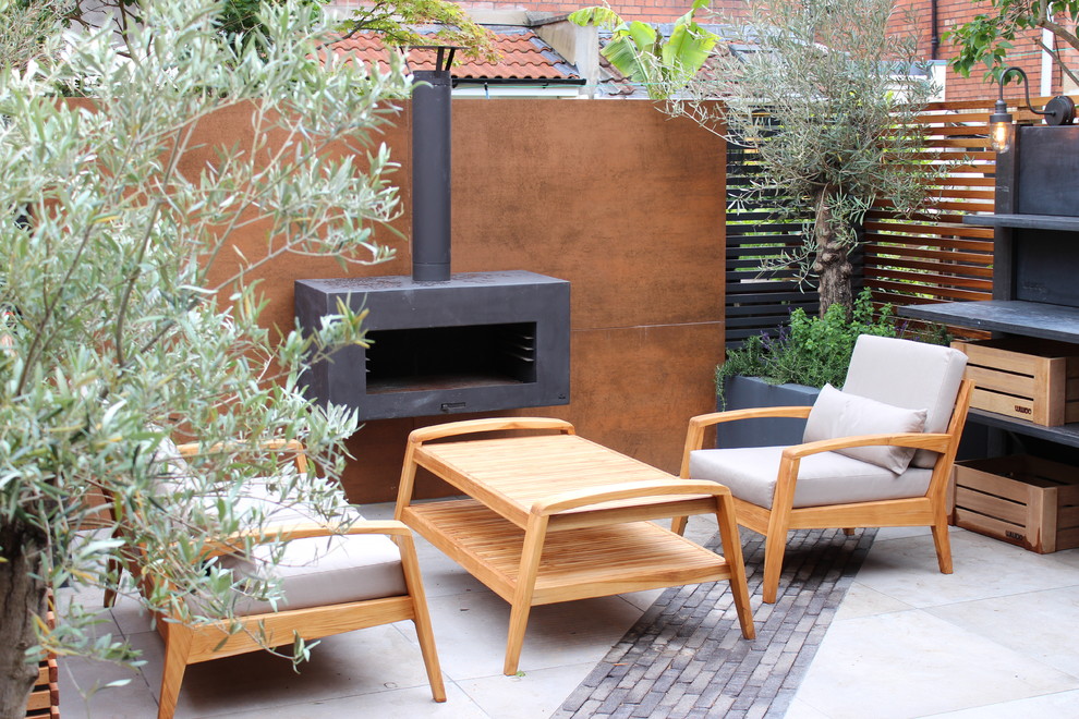 Small contemporary courtyard full sun xeriscape in Other with with fireplace for summer.