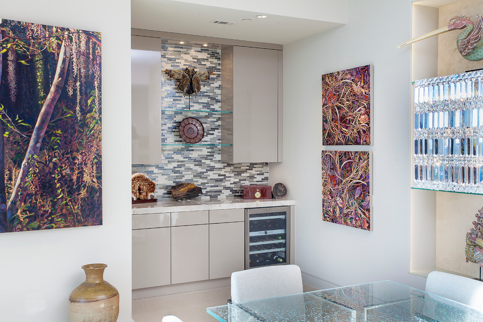Inspiration for a mid-sized contemporary single-wall wet bar in Houston with flat-panel cabinets, beige cabinets, multi-coloured splashback, subway tile splashback, quartzite benchtops and white floor.