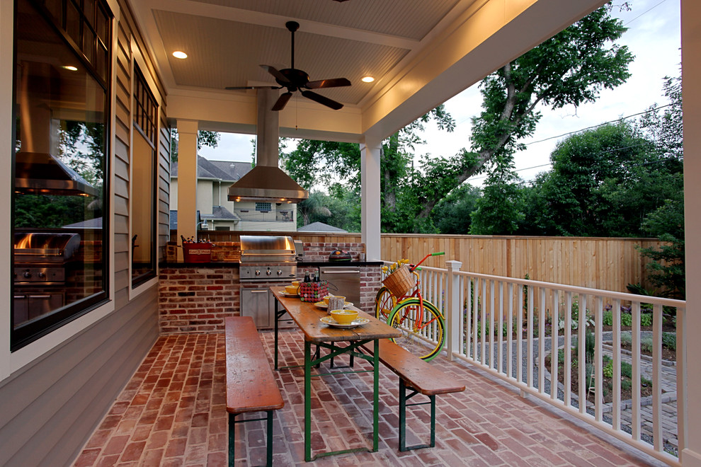 This is an example of a mid-sized traditional backyard verandah in Houston with brick pavers and a roof extension.