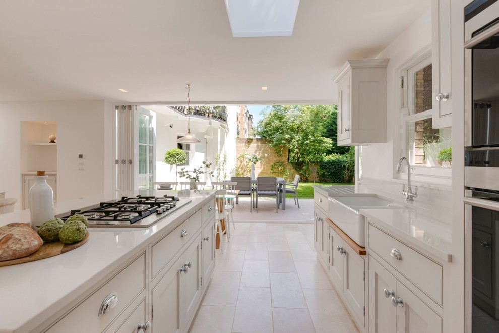 This is an example of a large modern kitchen in London with an island.
