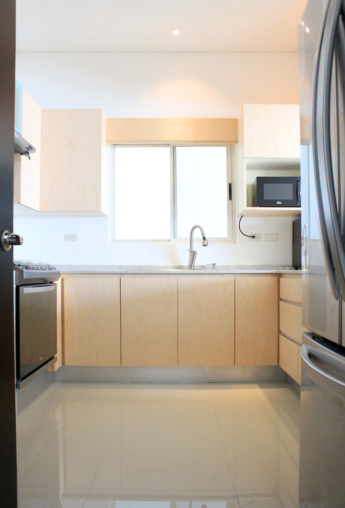 Eat-in kitchen - mid-sized modern u-shaped porcelain tile eat-in kitchen idea with a double-bowl sink, flat-panel cabinets, light wood cabinets, granite countertops and stainless steel appliances