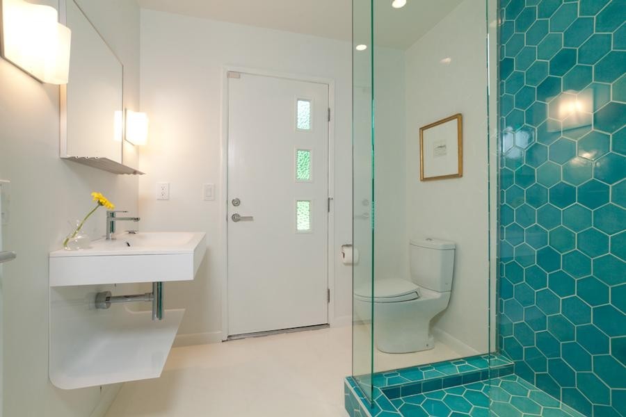 Inspiration for a mid-sized modern 3/4 blue tile and ceramic tile terrazzo floor corner shower remodel in Sacramento with white walls, a wall-mount sink and a one-piece toilet