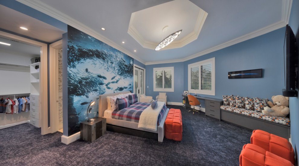 This is an example of an expansive transitional kids' bedroom for kids 4-10 years old and boys in Miami with blue walls, carpet, blue floor and recessed.