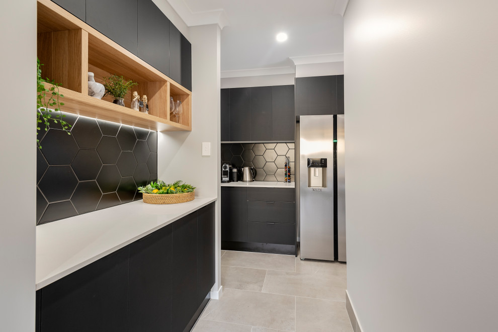 Photo of a mid-sized contemporary galley open plan kitchen in Sunshine Coast with an undermount sink, black splashback and grey floor.