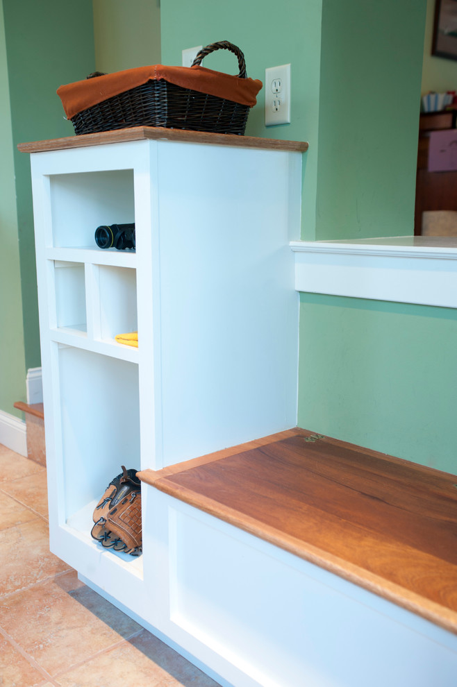 Design ideas for a small modern mudroom in Philadelphia with green walls and ceramic floors.