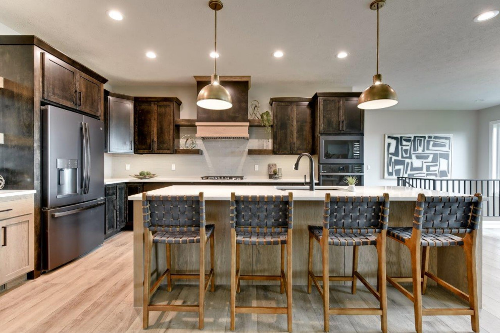 Transitional l-shaped open concept kitchen photo with shaker cabinets, white backsplash, an island and white countertops