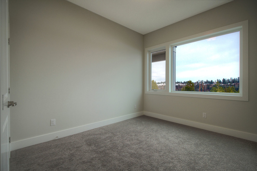 Photo of a mid-sized modern guest bedroom in Vancouver with grey walls, carpet and no fireplace.