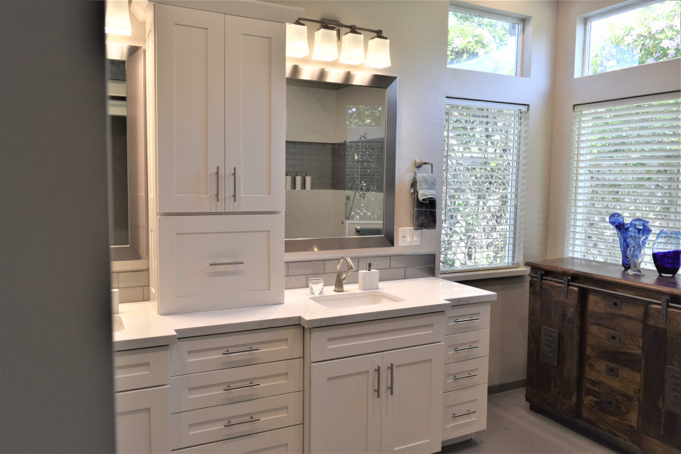 Photo of a large transitional master bathroom in San Francisco with shaker cabinets, white cabinets, a double shower, a one-piece toilet, gray tile, glass tile, grey walls, porcelain floors, an undermount sink, engineered quartz benchtops, grey floor, an open shower, white benchtops, a shower seat, a double vanity and a built-in vanity.