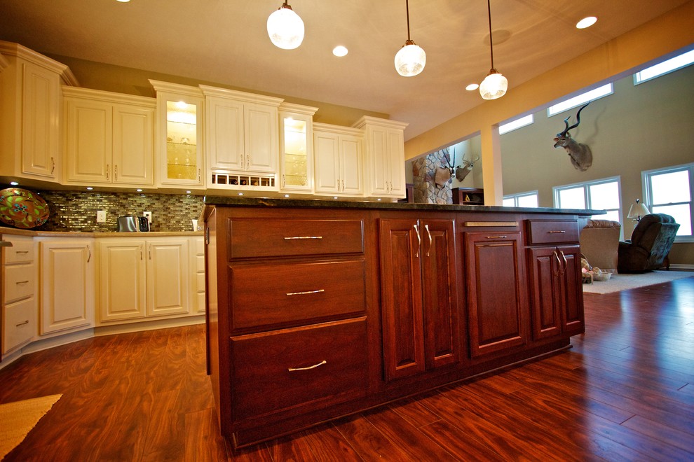 Inspiration for a mid-sized open concept kitchen remodel with raised-panel cabinets, dark wood cabinets, granite countertops and an island