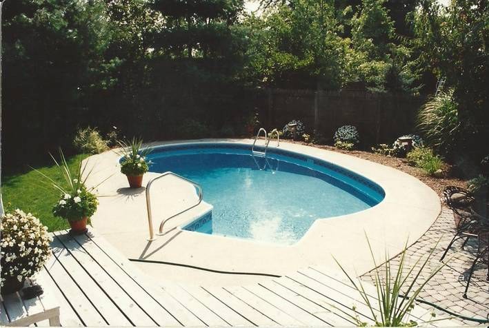 Large backyard custom-shaped pool photo in Grand Rapids