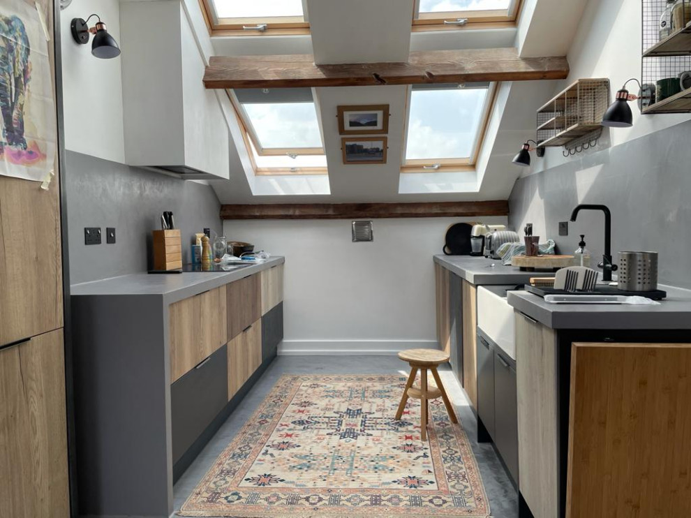 Small eclectic galley open plan kitchen with concrete flooring, no island, grey floors, grey worktops, exposed beams and feature lighting.