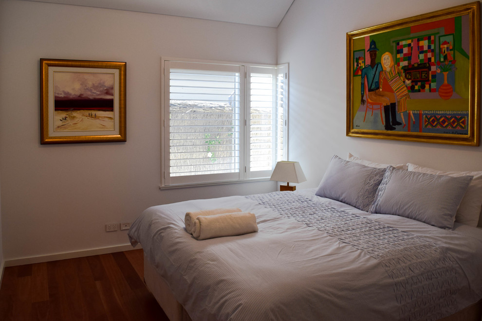 Mid-sized transitional guest bedroom in Perth with white walls, dark hardwood floors, no fireplace and brown floor.