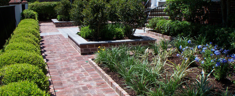 Inspiration for a mid-sized backyard patio in Charleston with a container garden, brick pavers and no cover.