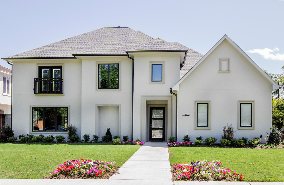 Inspiration for a large transitional two-storey stucco grey exterior in Dallas.