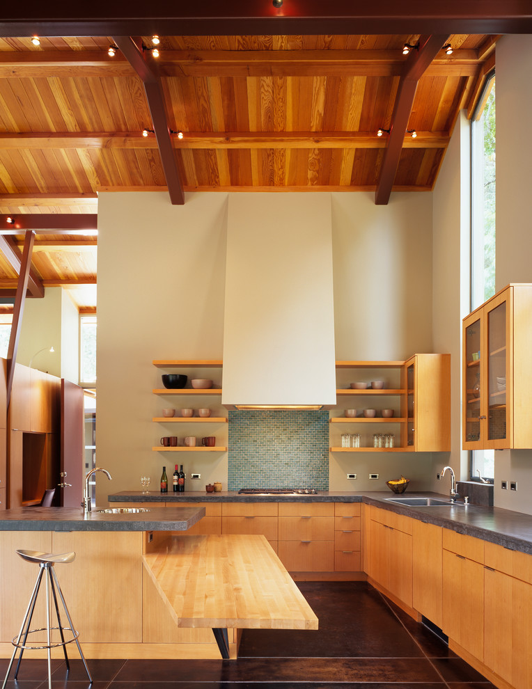 Contemporary l-shaped open plan kitchen in San Francisco with a drop-in sink, flat-panel cabinets, light wood cabinets, concrete benchtops, blue splashback, with island and brown floor.