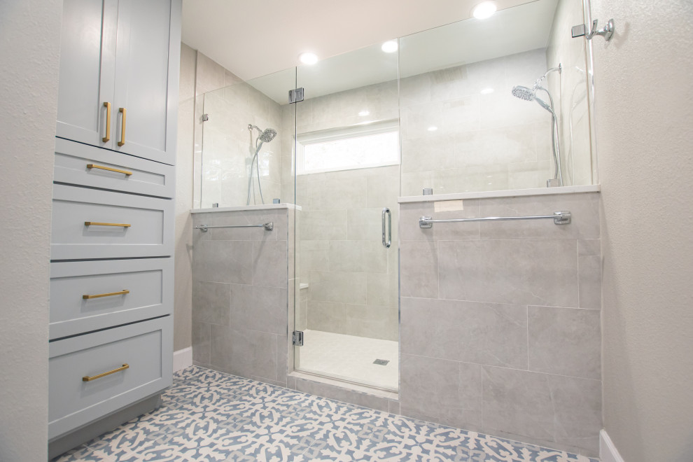 Photo of a transitional master bathroom in Austin with shaker cabinets, grey cabinets, a double shower, a two-piece toilet, gray tile, porcelain tile, porcelain floors, an undermount sink, engineered quartz benchtops, blue floor, a hinged shower door, white benchtops, a double vanity and a built-in vanity.