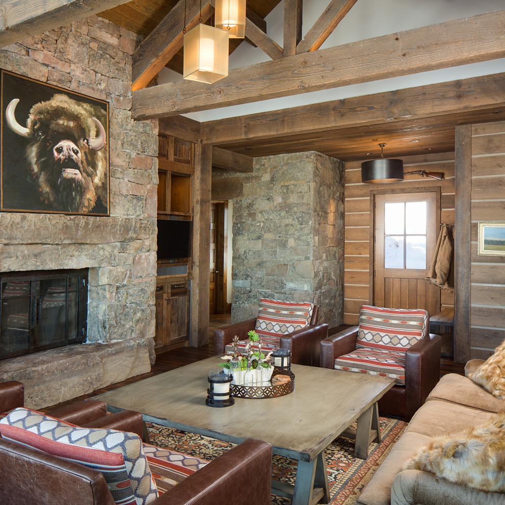 Country living room in Salt Lake City with brown walls, a built-in media wall, a standard fireplace and a stone fireplace surround.