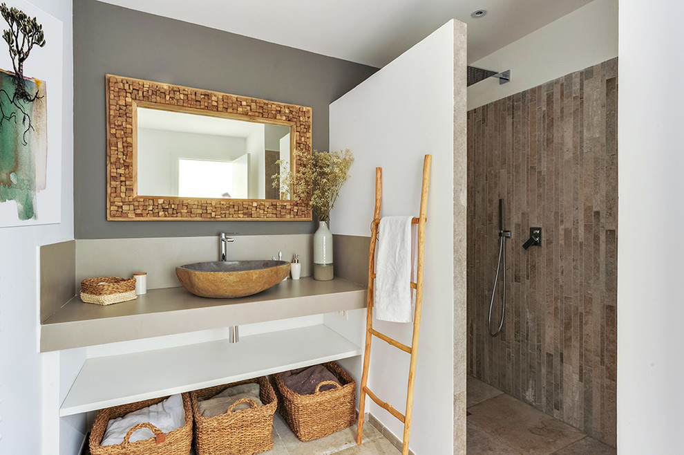 This is an example of a mid-sized eclectic 3/4 bathroom in Corsica with a curbless shower, beige walls, ceramic floors, a vessel sink, tile benchtops, beige floor and beige benchtops.