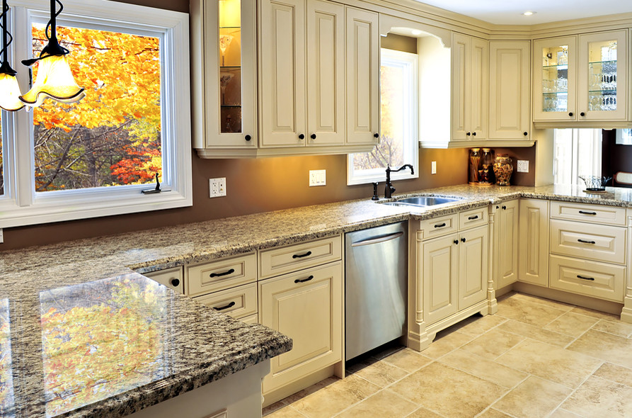 Enclosed kitchen - mid-sized transitional u-shaped ceramic tile and beige floor enclosed kitchen idea in Miami with a farmhouse sink, raised-panel cabinets, white cabinets, beige backsplash, matchstick tile backsplash, stainless steel appliances and an island