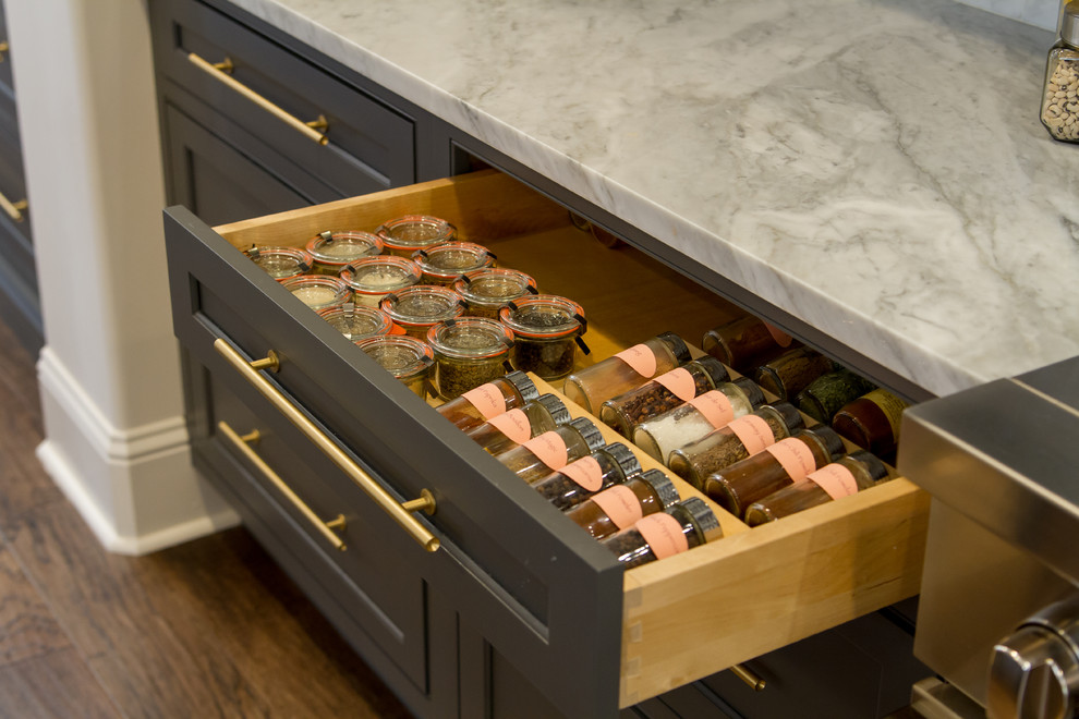 Transitional medium tone wood floor and brown floor eat-in kitchen photo with beaded inset cabinets, gray cabinets, white backsplash, paneled appliances, an island and white countertops