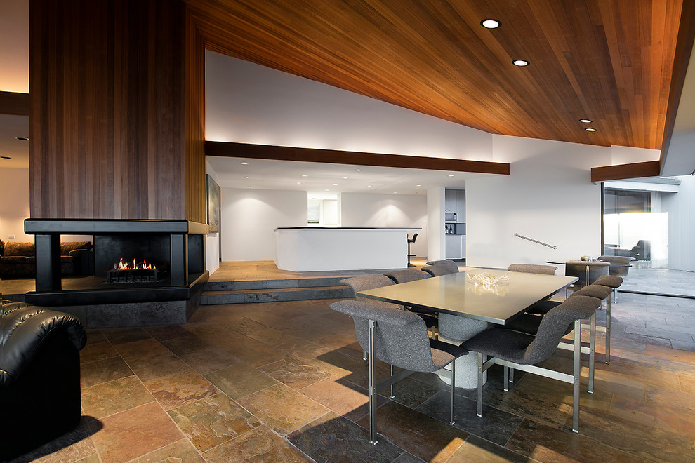 Design ideas for a contemporary open plan dining in San Francisco with white walls and a two-sided fireplace.