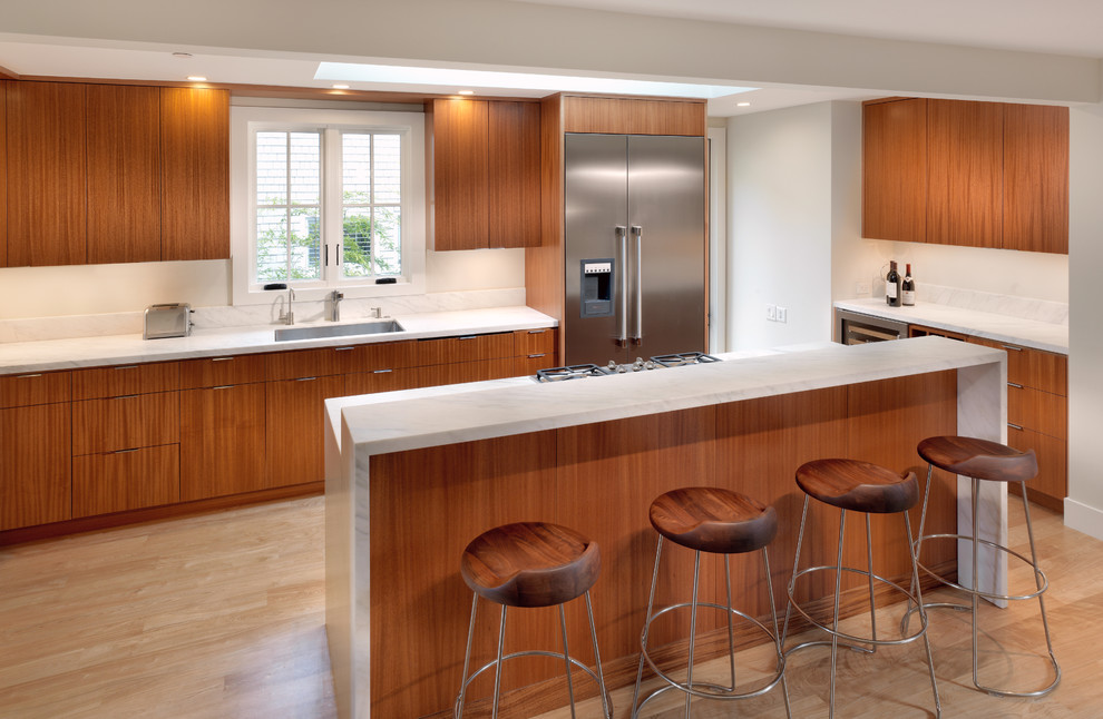 Design ideas for a modern l-shaped kitchen in San Francisco with stainless steel appliances, flat-panel cabinets and medium wood cabinets.
