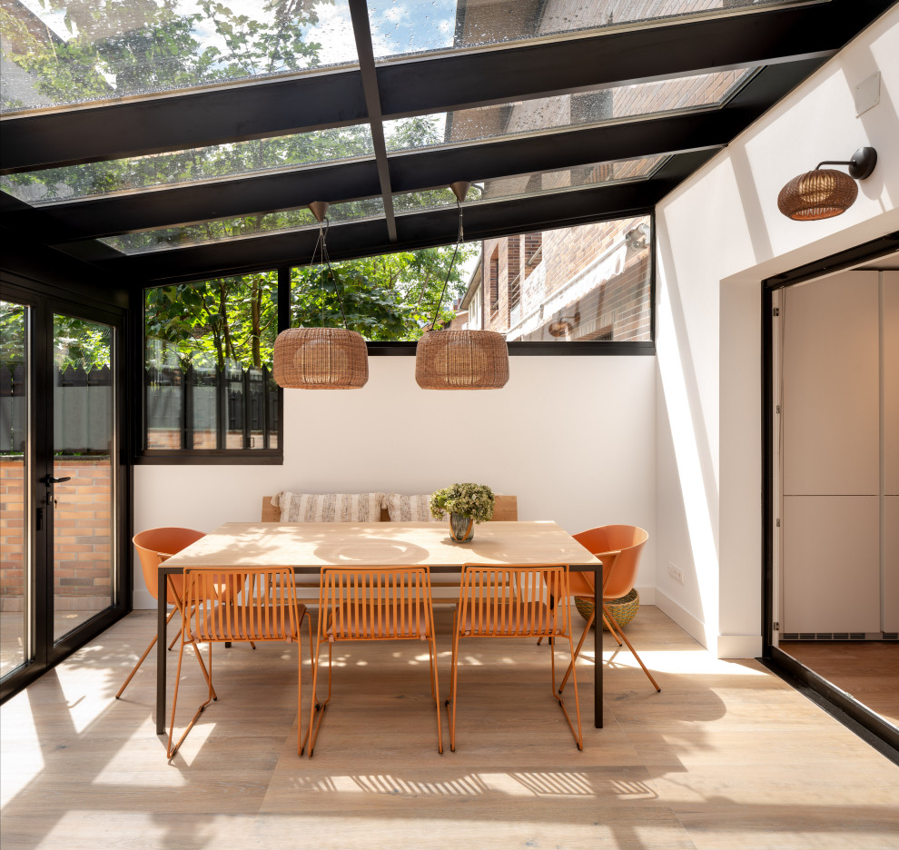 This is an example of a large scandinavian open plan dining in Bilbao with white walls, ceramic floors, no fireplace, beige floor and wallpaper.