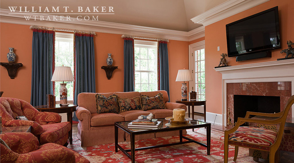 Inspiration for a large traditional enclosed living room in Atlanta with orange walls, dark hardwood floors, a standard fireplace and a wood fireplace surround.